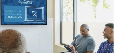 3 patients view waiting room screen showing My HealtheVet online prescription management message.